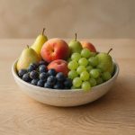 Fresh fruits bowl on wooden table - illustration for 15 daily habits that boost heart, brain, and overall health naturally