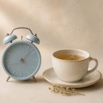 Alarm clock beside a cup of herbal tea - illustration for How Changes in Daily Routine Can Affect Your Normal Sleep Pattern