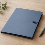 Closed folder on wooden desk with pen - illustration for How Clinics Handle Patient Privacy and Confidentiality