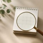 Magnifying glass over a small calendar - illustration for How Early Screening Helps Prevent Cancer
