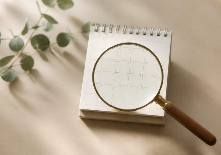 Magnifying glass over a small calendar - illustration for How Early Screening Helps Prevent Cancer