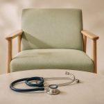 Waiting room chair with a stethoscope on table - illustration for How Regular Clinic Visits Improve Overall Wellness