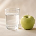Glass of water next to fresh green apple - illustration for Kidney Health: When to Check Creatinine and Other Tests
