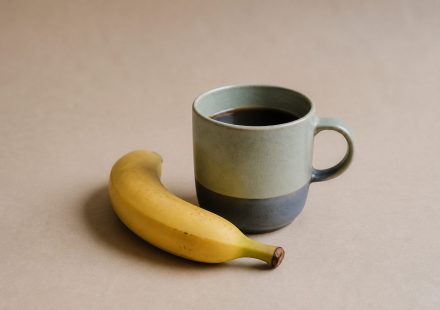Cup of coffee with a ripe banana - illustration for Morning Habits for Better Health