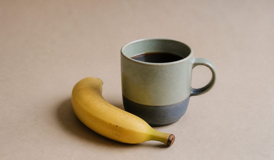 Cup of coffee with a ripe banana - illustration for Morning Habits for Better Health