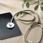 Stethoscope and digital tablet on wooden table - illustration for How modern medical technology is improving patient care and outcomes
