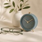 Nightstand with alarm clock and eyeglasses - illustration for how better sleep boosts your overall health and wellness
