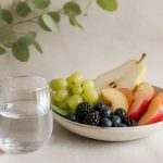 Glass of water and fresh fruit bowl - illustration for How small lifestyle changes can prevent chronic diseases
