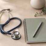 Stethoscope beside a notebook and pen - illustration for Why having a trusted primary care doctor benefits your health for life