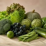 Fresh fruits and vegetables on wooden table - illustration for how nutrition plays a key role in preventive medicine and health