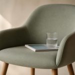 Waiting room chair with magazine and water cup - illustration for What to Expect During Your First Clinic Visit