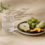 Glass of water, plate of fruit, kitchen table - illustration for What your annual blood tests really reveal about health