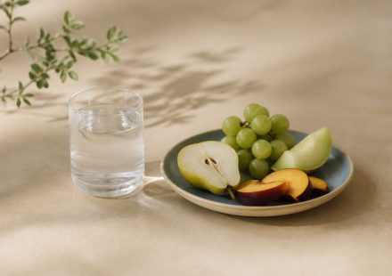 Glass of water, plate of fruit, kitchen table - illustration for What your annual blood tests really reveal about health