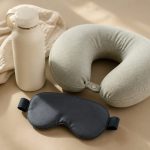 Eye mask water bottle neck pillow on tray table - illustration for Why Long Flights Can Affect the Body Differently