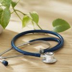 Stethoscope on a wooden desk with plant - illustration for Why Patient-Centered Care Is Shaping the Future of Healthcare: The Key to Better Outcomes and Personalized Treatment