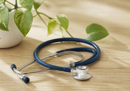 Stethoscope on a wooden desk with plant - illustration for Why Patient-Centered Care Is Shaping the Future of Healthcare: The Key to Better Outcomes and Personalized Treatment