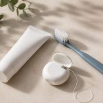 Toothbrush toothpaste and dental floss on countertop - illustration for Why regular dental care matters for your overall health