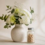 Vase with fresh flowers and vitamins bottle - illustration for Why Women Should Visit a Women’s Health Clinic Regularly