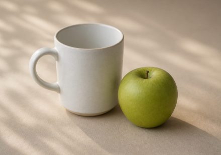 White ceramic mug and fresh green apple on table - illustration for Why your blood pressure readings matter at every checkup